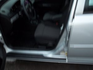 A car door open with the driver 's side door ajar.