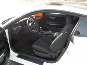 A white car with orange and black interior.